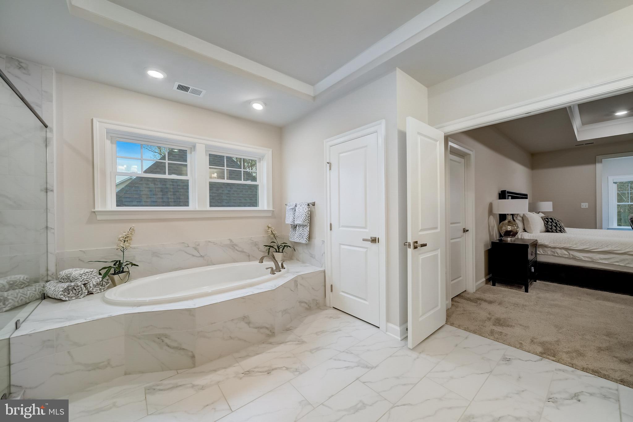 6 Gershwin Drive West Chester, PA 19380 - Photo 43 of 79 a spacious bathroom with a tub sink and mirror