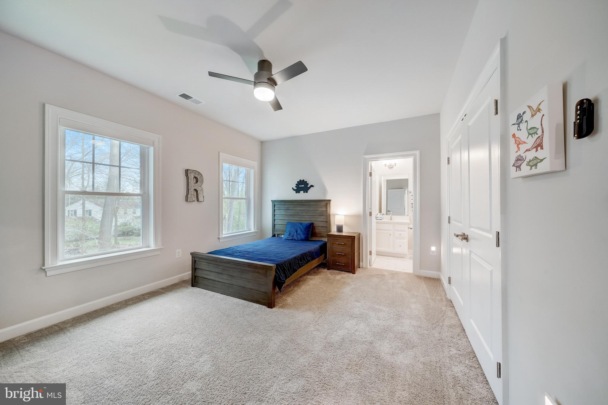 6 Gershwin Drive West Chester, PA 19380 - Photo 56 of 79 a spacious bedroom with a bed and a chandelier