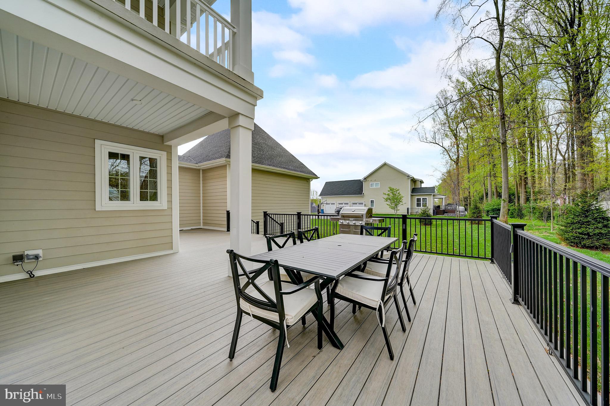 6 Gershwin Drive West Chester, PA 19380 - Photo 75 of 79 a view of a roof deck with table and chairs a barbeque with wooden floor and fence