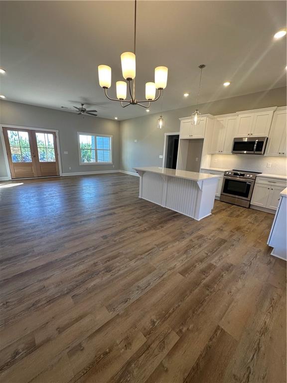 5207 Lee Road Salem, AL 36874 - Photo 23 of 23 Kitchen with open floor plan, stove, dark wood-style flooring, suspended lighting, and white cabinets