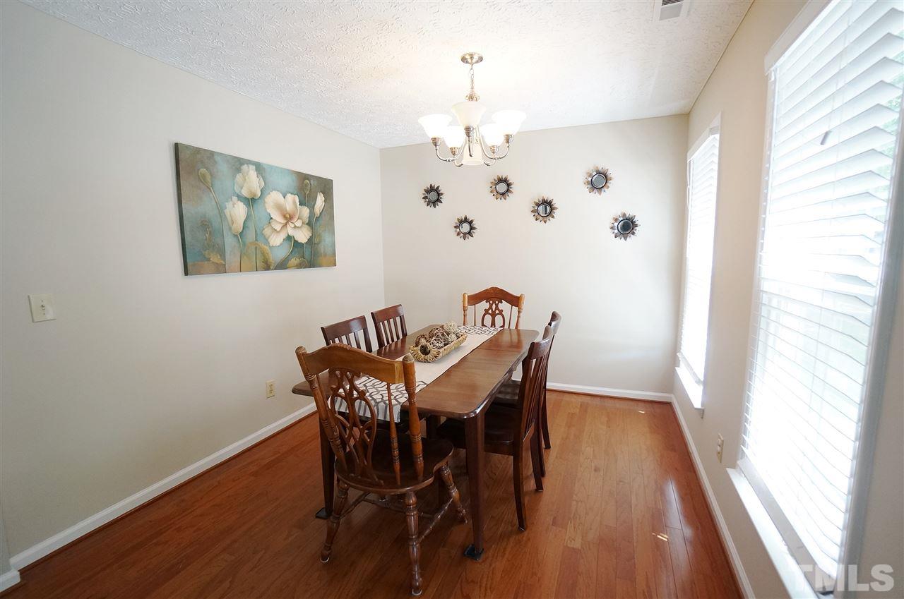 5401 Spring Pines Way Raleigh, NC 27616 - Photo 2 of 16 a view of a dining room with furniture and wooden floor