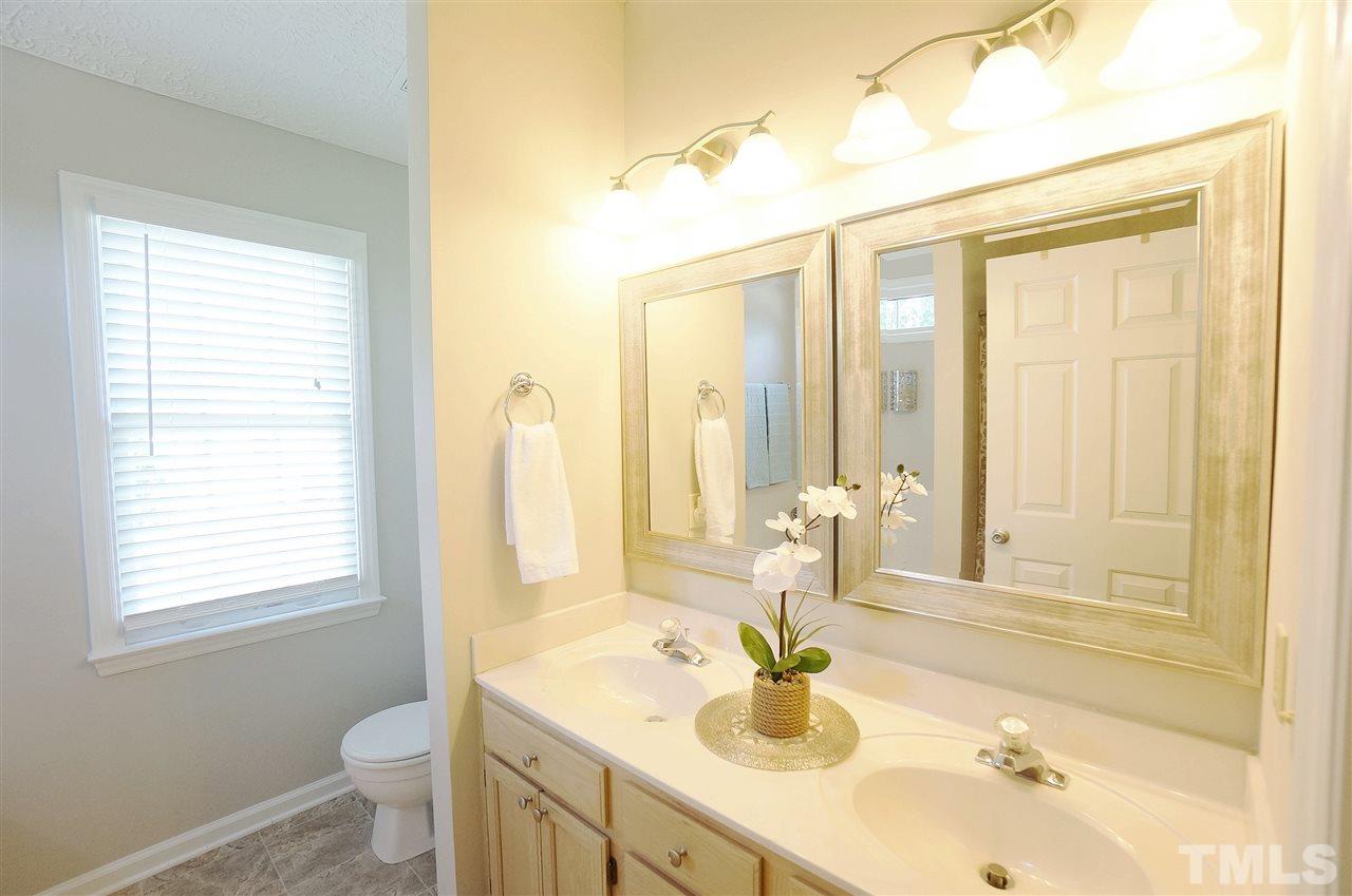 5401 Spring Pines Way Raleigh, NC 27616 - Photo 11 of 16 a bathroom with a sink and a mirror