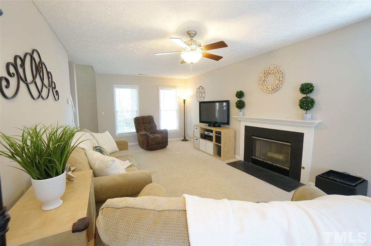5401 Spring Pines Way Raleigh, NC 27616 - Photo 3 of 16 a living room with furniture a fireplace and a potted plant