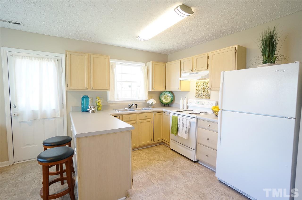 5401 Spring Pines Way Raleigh, NC 27616 - Photo 5 of 16 a kitchen with appliances a sink and a refrigerator