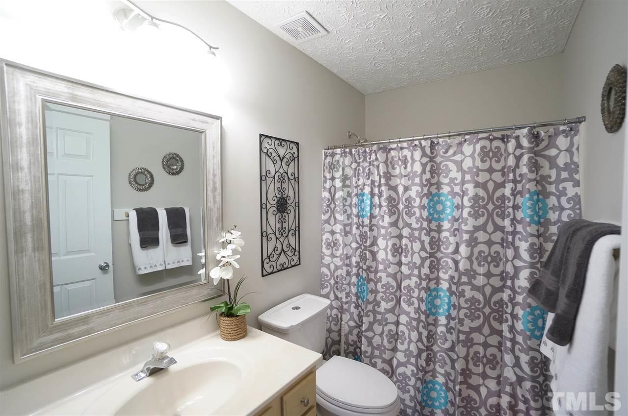 5401 Spring Pines Way Raleigh, NC 27616 - Photo 8 of 16 a bathroom with a sink a toilet and shower curtain