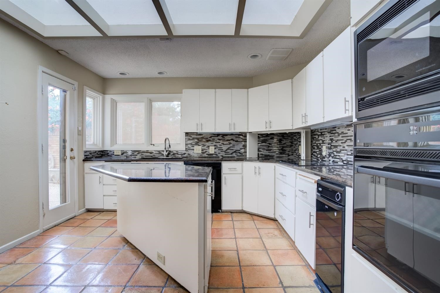 4902 92nd Street Lubbock, TX 79424 - Photo 18 of 44 a kitchen with stainless steel appliances granite countertop a stove sink and cabinets