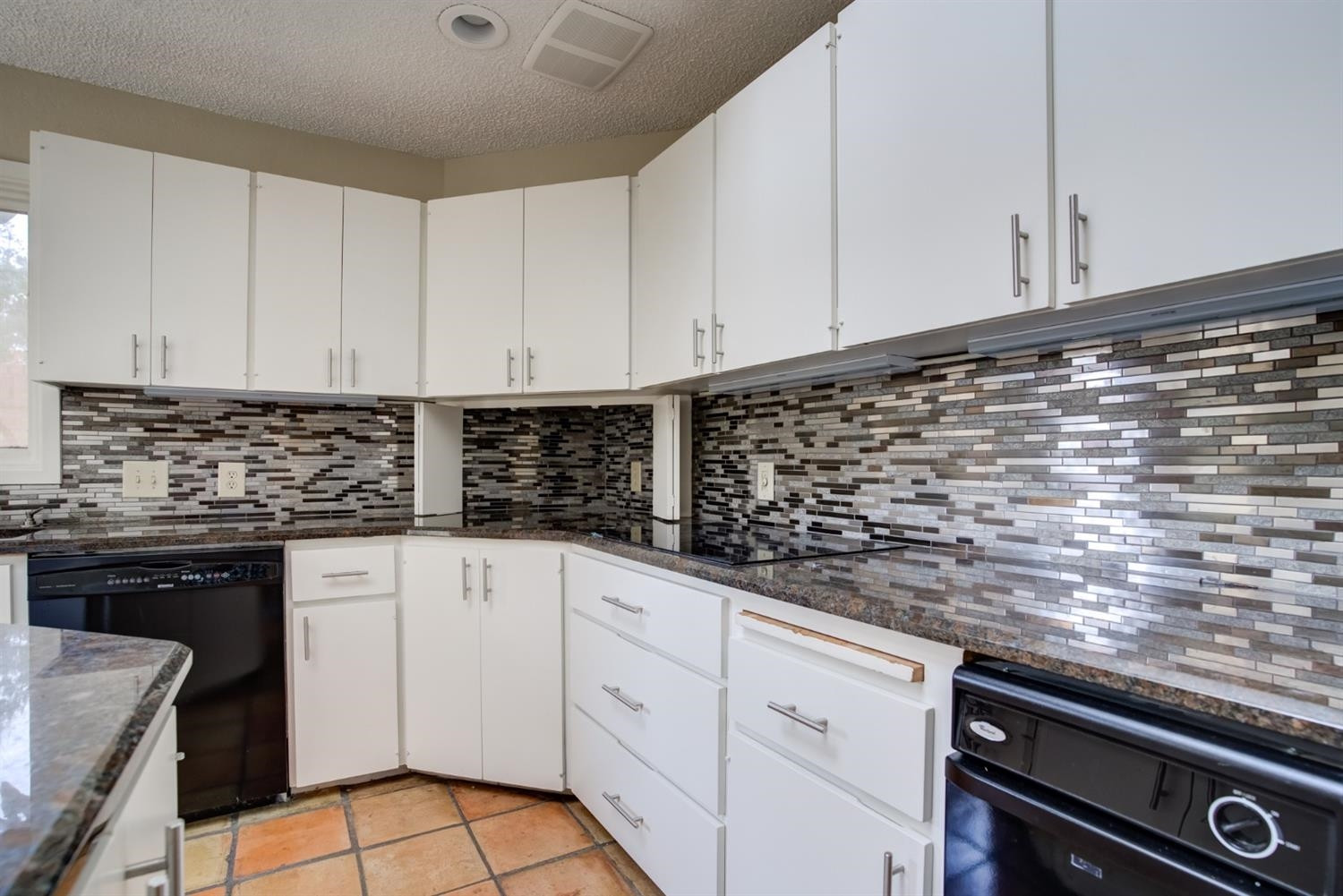 4902 92nd Street Lubbock, TX 79424 - Photo 19 of 44 a kitchen with granite countertop white cabinets and white appliances