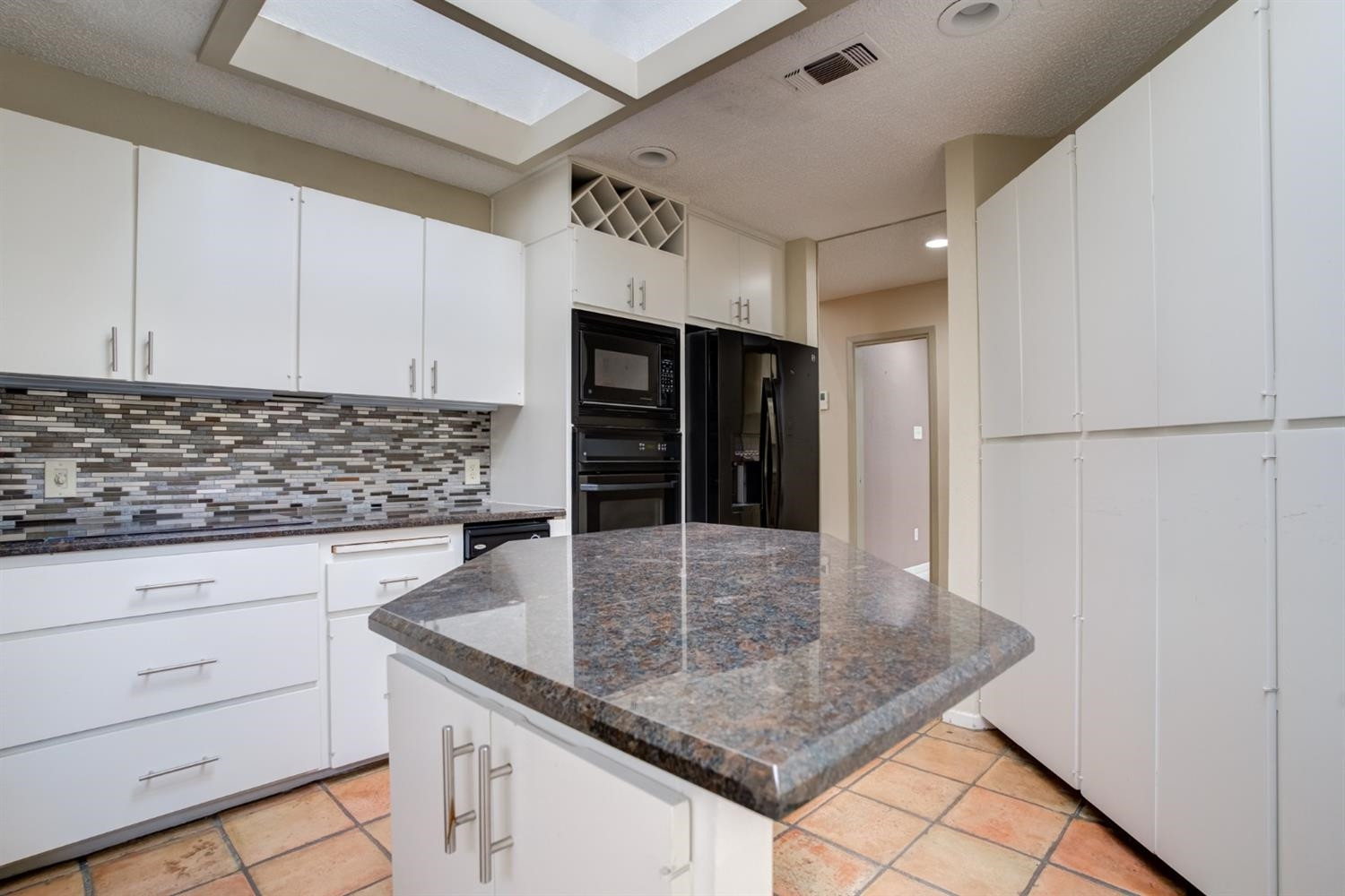 4902 92nd Street Lubbock, TX 79424 - Photo 21 of 44 a kitchen with stainless steel appliances granite countertop a sink window and cabinets