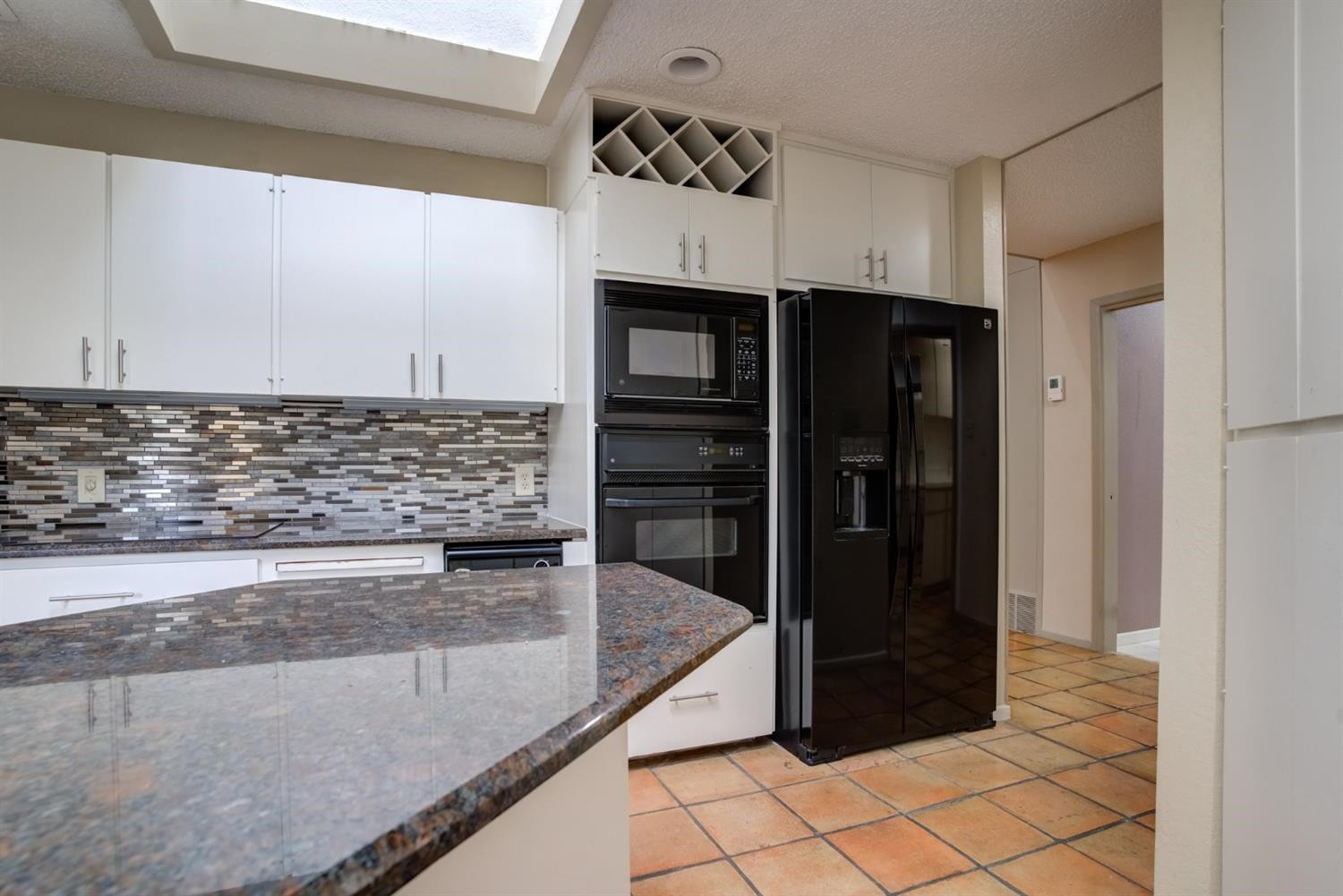 4902 92nd Street Lubbock, TX 79424 - Photo 23 of 44 a kitchen with stainless steel appliances granite countertop a refrigerator and a stove