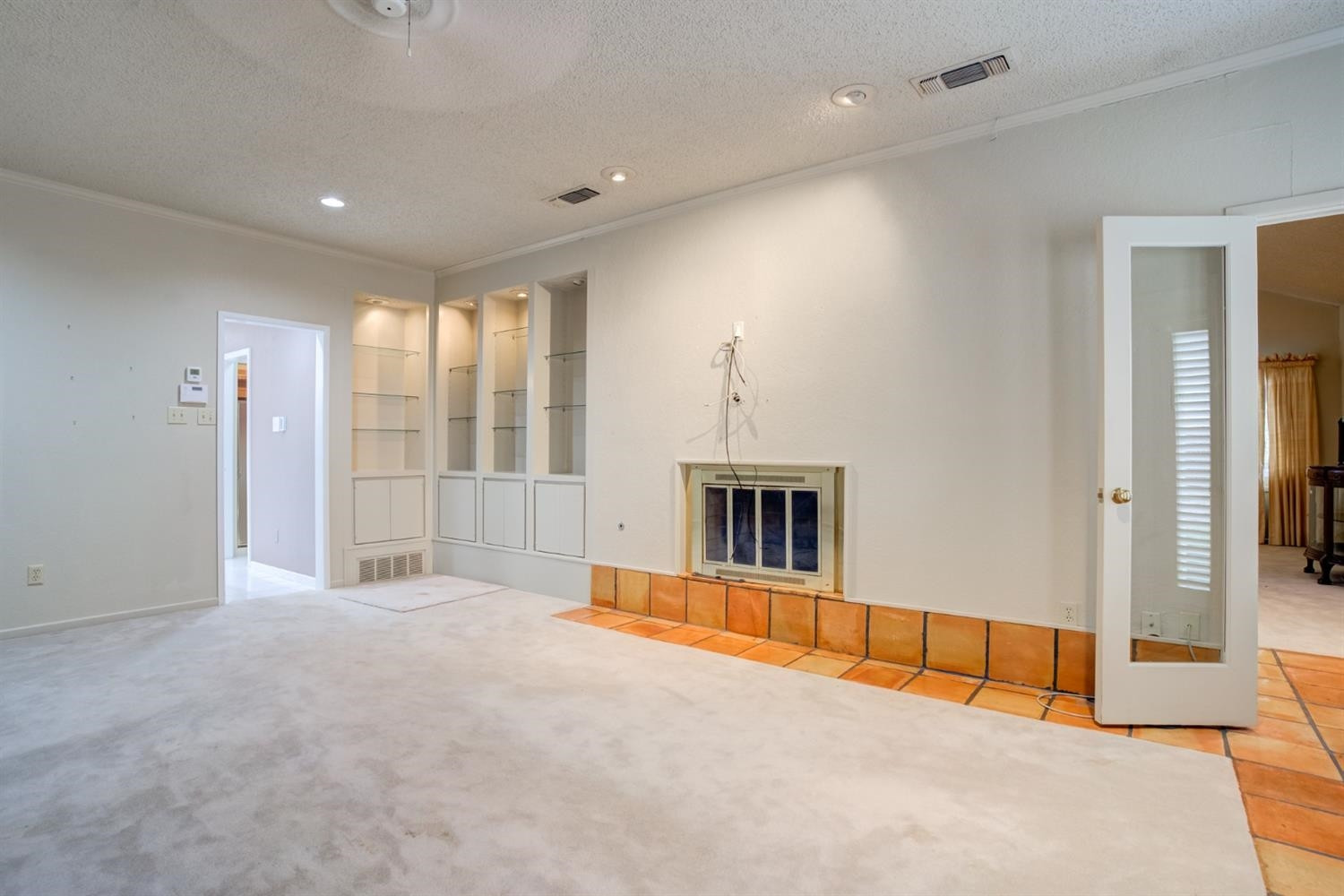 4902 92nd Street Lubbock, TX 79424 - Photo 26 of 44 a view of an empty room with a fireplace and a window