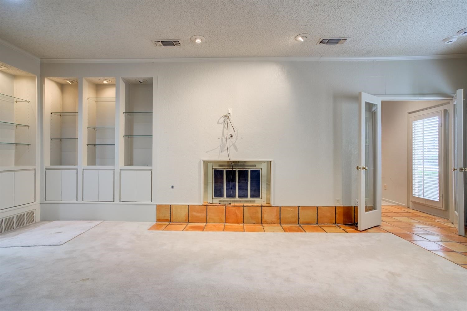 4902 92nd Street Lubbock, TX 79424 - Photo 27 of 44 a view of an empty room with a fireplace and a window