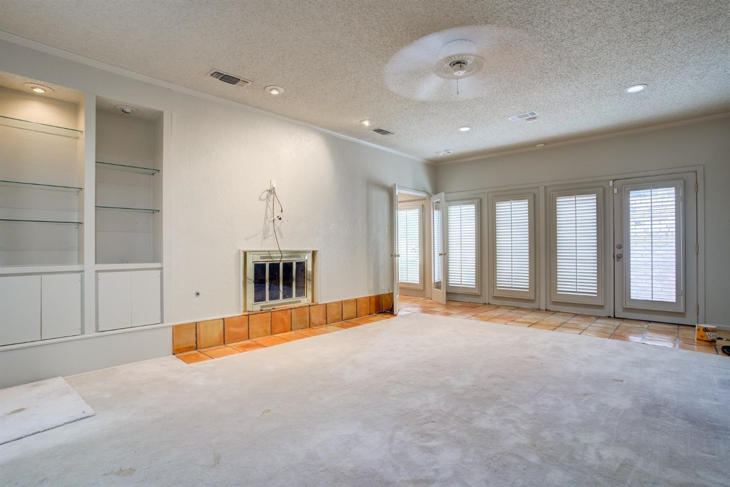 4902 92nd Street Lubbock, TX 79424 - Photo 28 of 44 a view of an empty room with a fireplace and a large window
