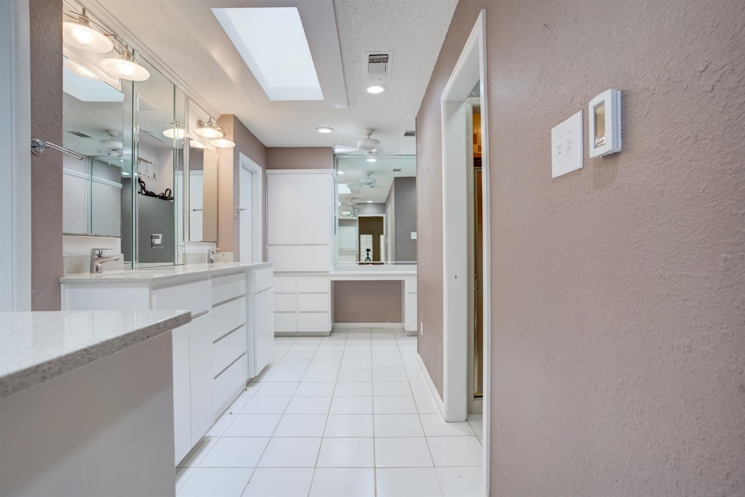 4902 92nd Street Lubbock, TX 79424 - Photo 30 of 44 a large white kitchen with a sink and dishwasher a refrigerator with white cabinets