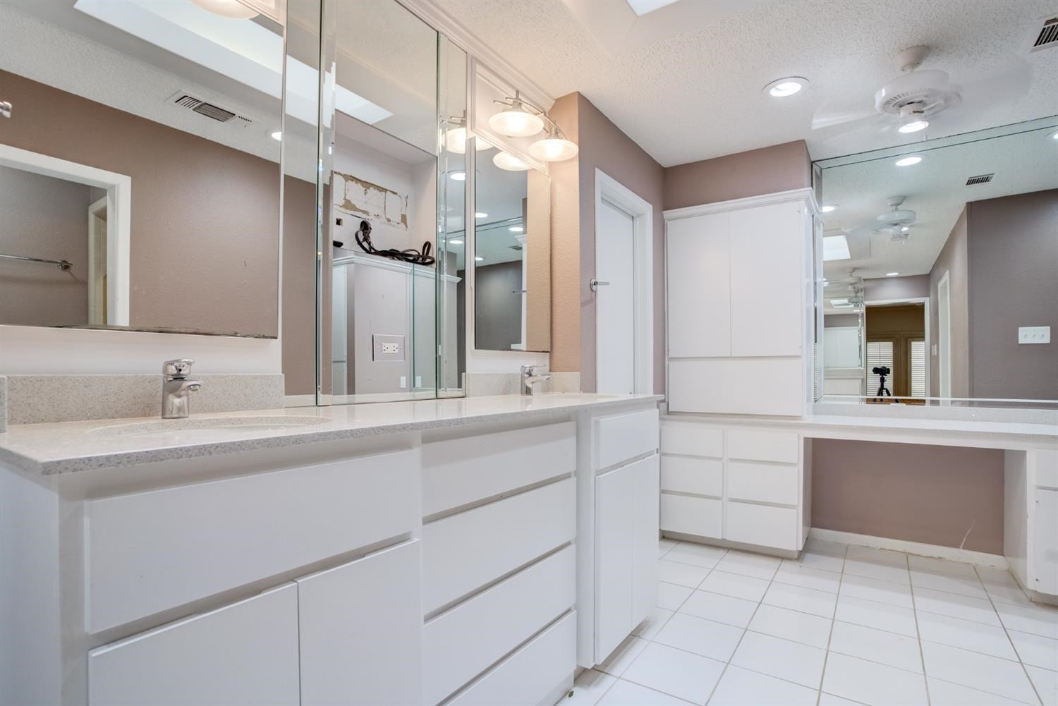 4902 92nd Street Lubbock, TX 79424 - Photo 31 of 44 a bathroom with a sink vanity and a mirror