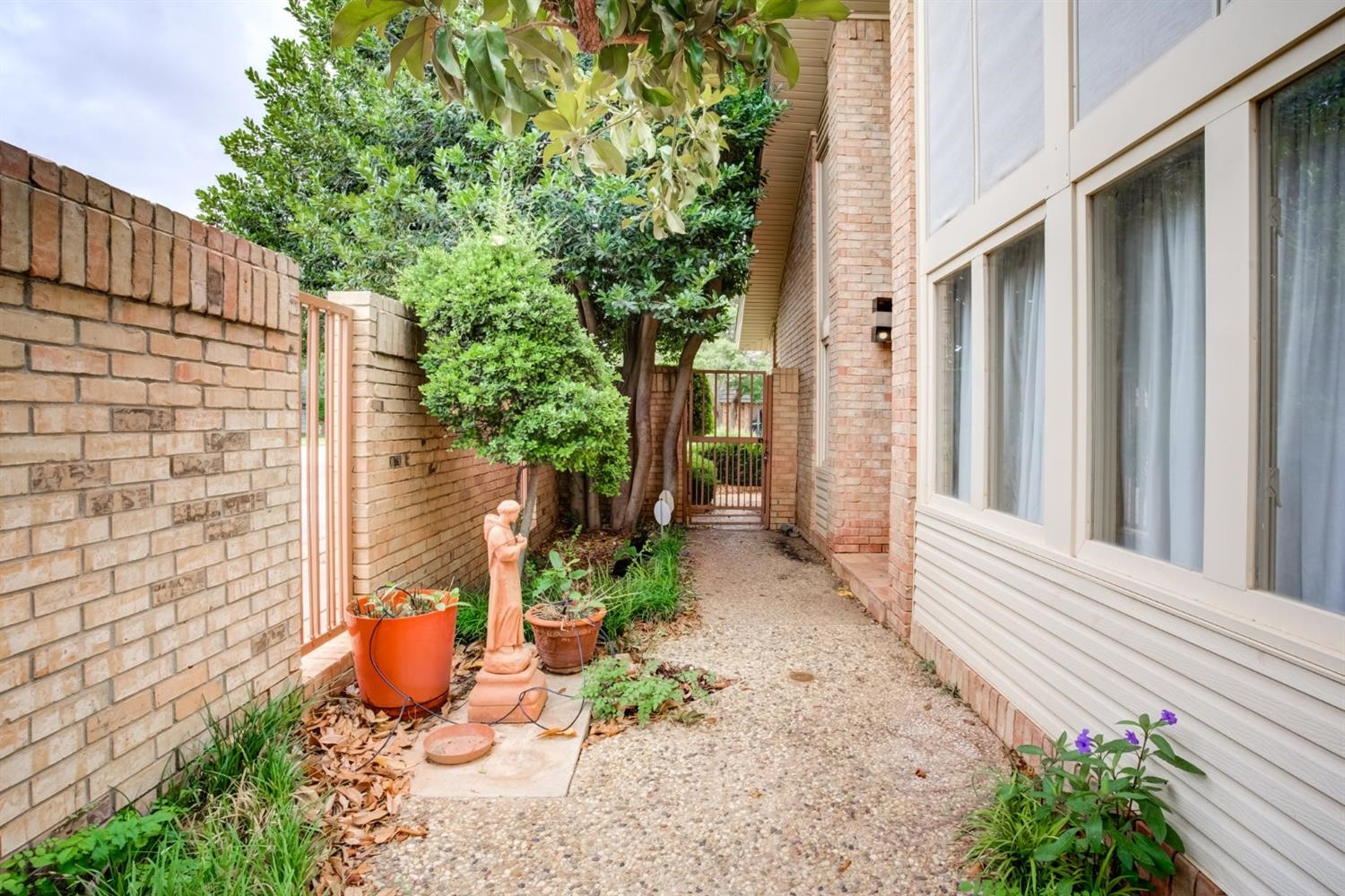 4902 92nd Street Lubbock, TX 79424 - Photo 44 of 44 a view of a backyard with plants and wooden fence