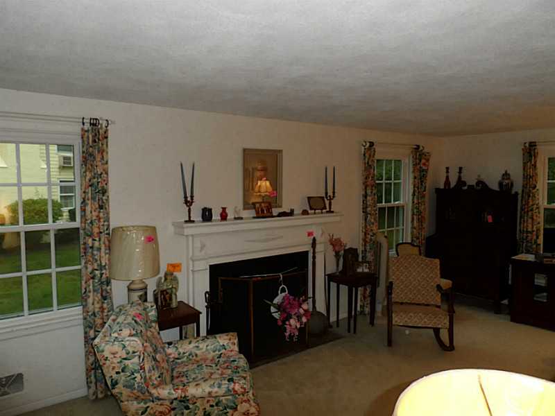 141 Timberline Road Warwick, RI 02886 - Photo 8 of 9 Living Room. The living room has hardwood floors and a wood burning fireplace