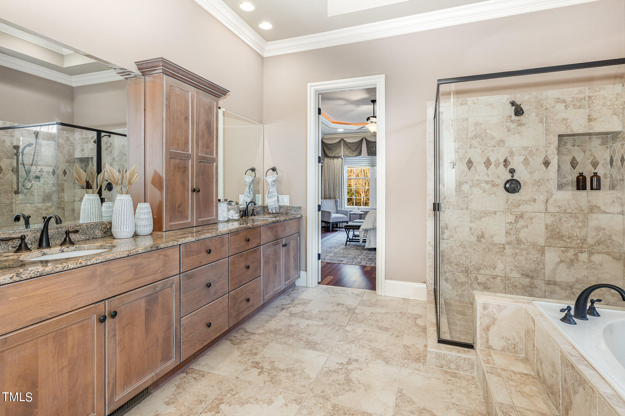 3028 Wyntree Ridge Way Raleigh, NC 27606 - Photo 16 of 39 a spacious bathroom with a double vanity sink a mirror a shower and a bathtub