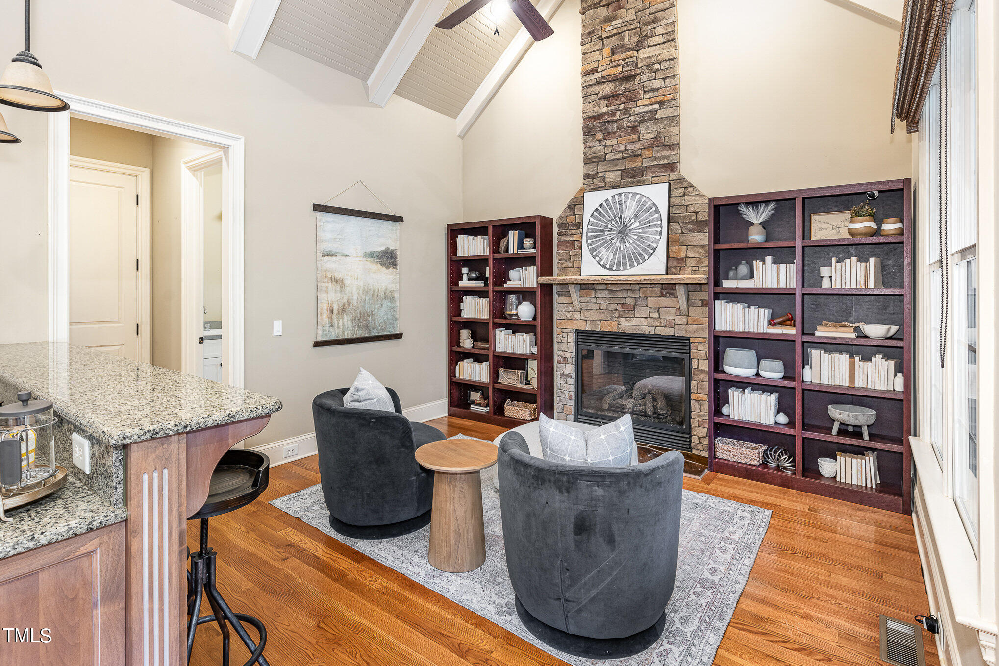 3028 Wyntree Ridge Way Raleigh, NC 27606 - Photo 10 of 39 a living room with furniture a bookshelf and a fireplace