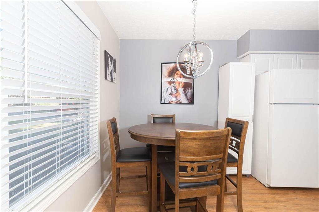 1348 Surrey Lane Southwest Marietta, GA 30008 - Photo 2 of 10 a view of a dining room with furniture and wooden floor