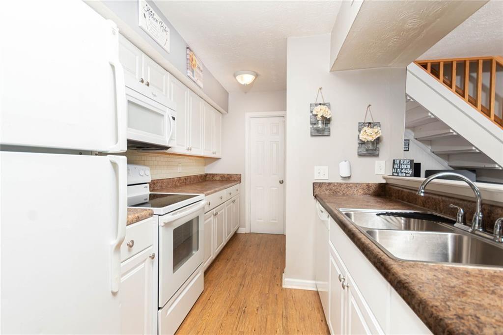 1348 Surrey Lane Southwest Marietta, GA 30008 - Photo 3 of 10 a kitchen with stainless steel appliances granite countertop a sink and a stove