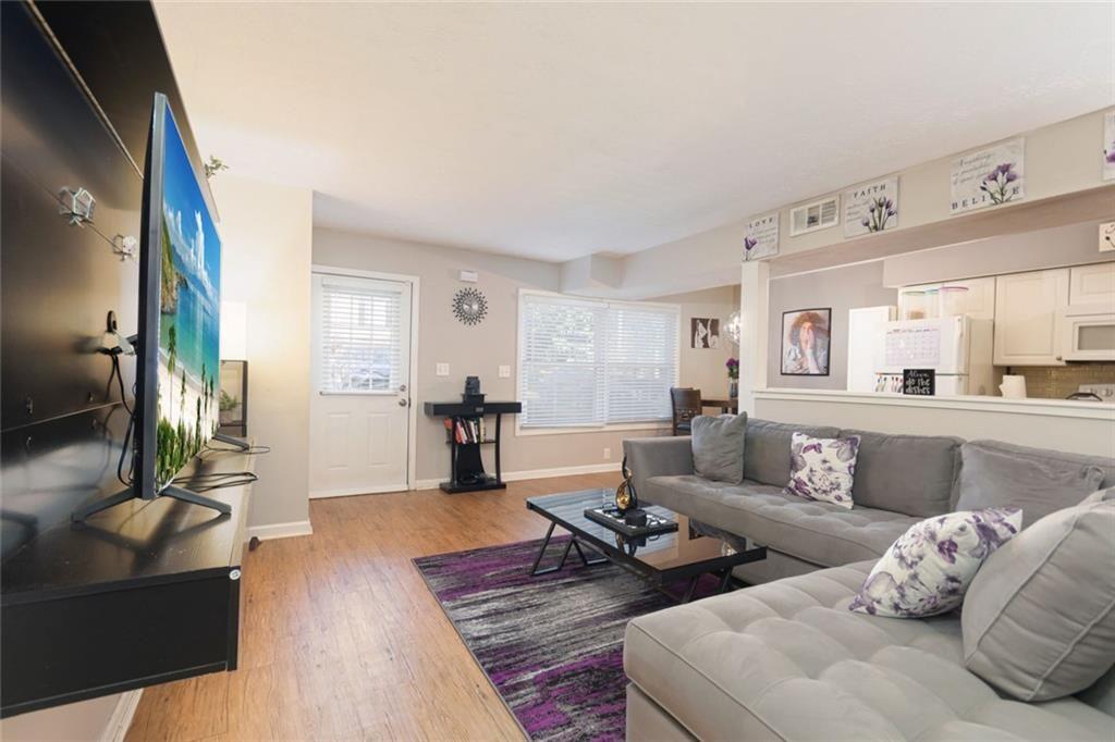 1348 Surrey Lane Southwest Marietta, GA 30008 - Photo 4 of 10 a living room with furniture wooden floor and a large window