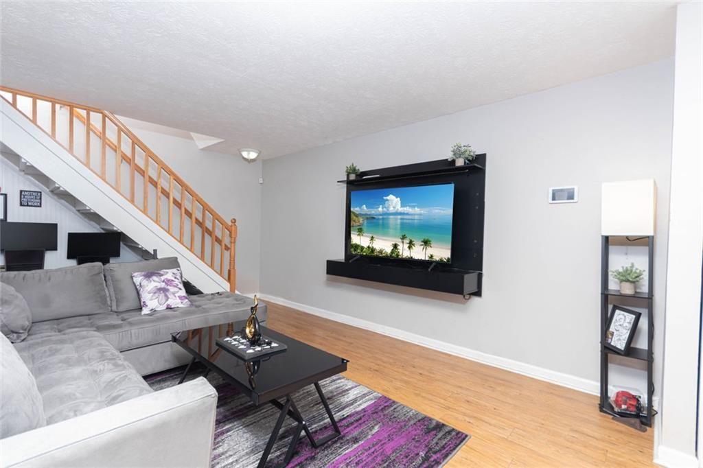 1348 Surrey Lane Southwest Marietta, GA 30008 - Photo 5 of 10 a living room with furniture and a flat screen tv