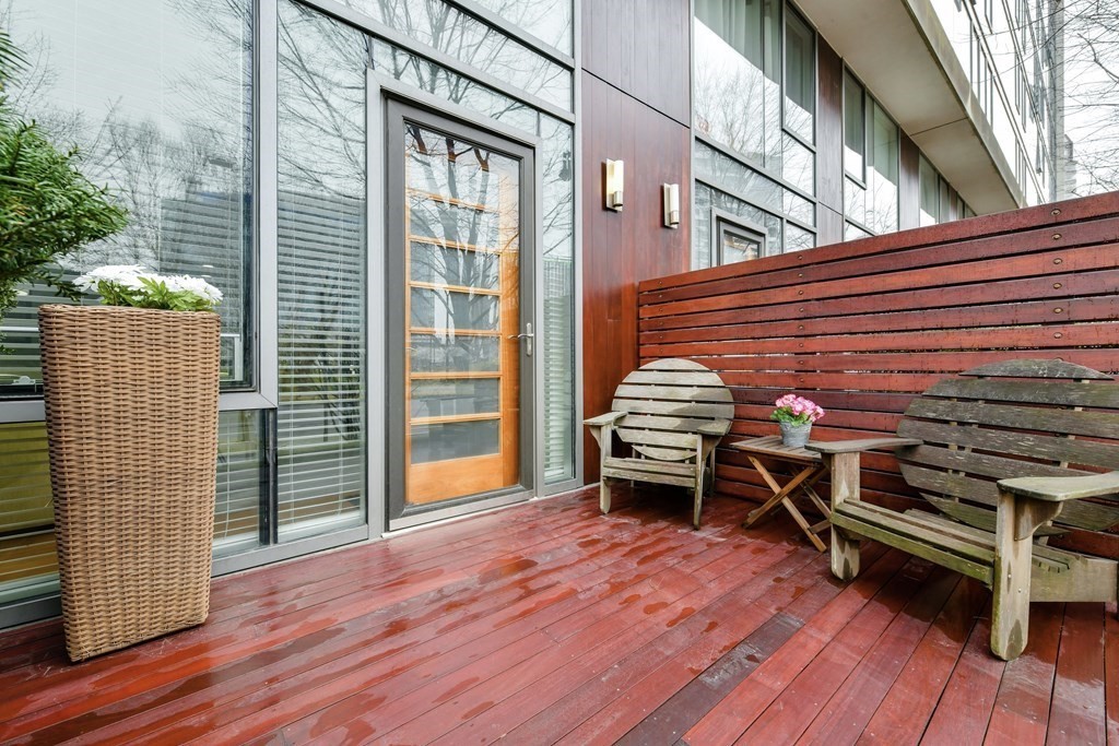 an outdoor space with wooden floor and seating space
