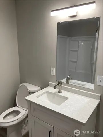 a bathroom with a sink toilet and vanity