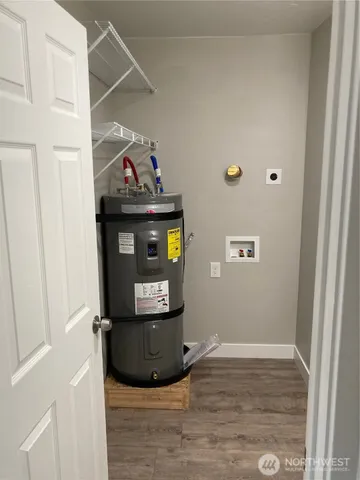 a view of a livingroom with wooden floor and staircase
