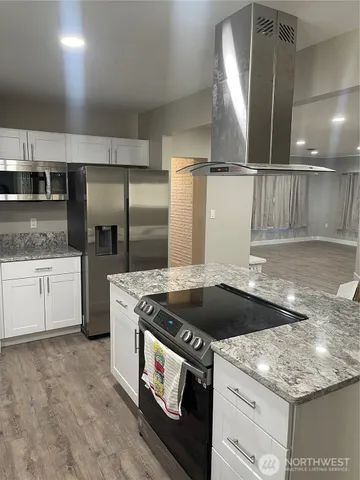 a kitchen with a stove and a refrigerator