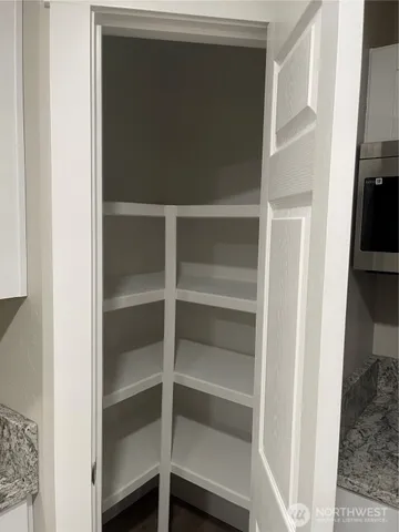 a view of walk in closet with empty racks