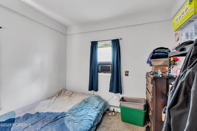a view of a bedroom with furniture and closet