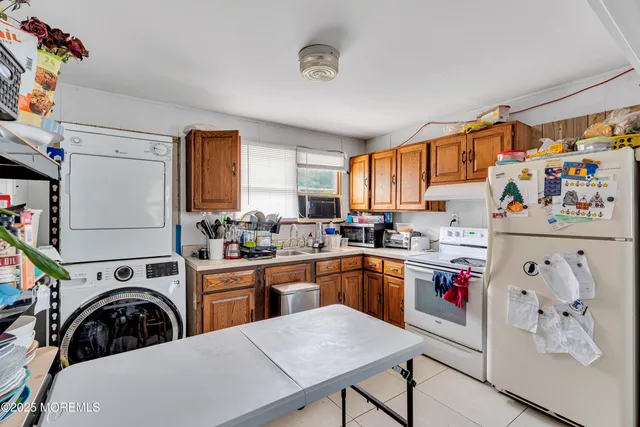 a view of kitchen with sink a stove and wooden floor