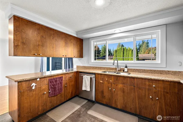 a kitchen with stainless steel appliances granite countertop a refrigerator and a stove