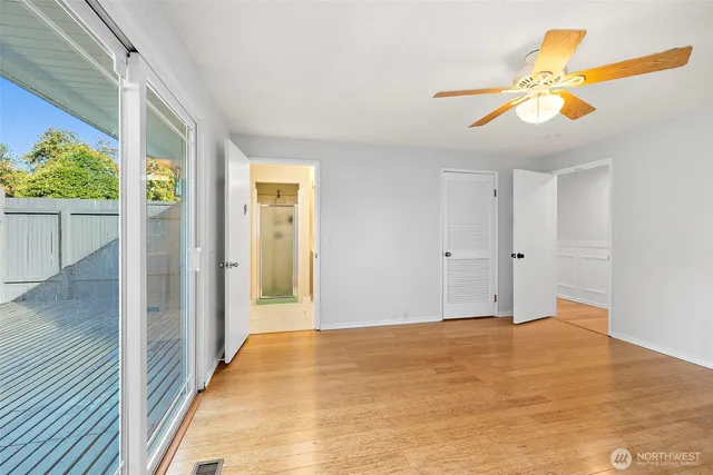 a view of empty room with wooden floor