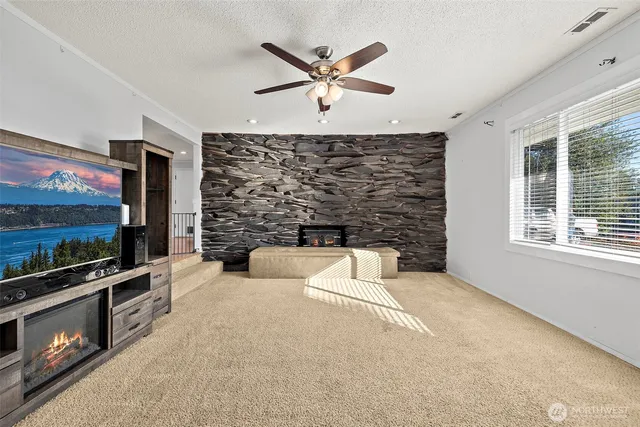 a living room with fireplace furniture and a flat screen tv