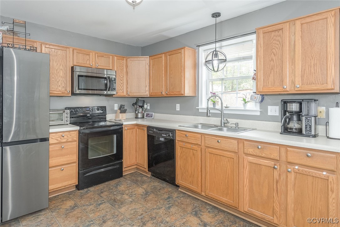6330 Oak Drive Quinton, VA 23141 - Photo 9 of 23 a kitchen with granite countertop white cabinets sink and stainless steel appliances