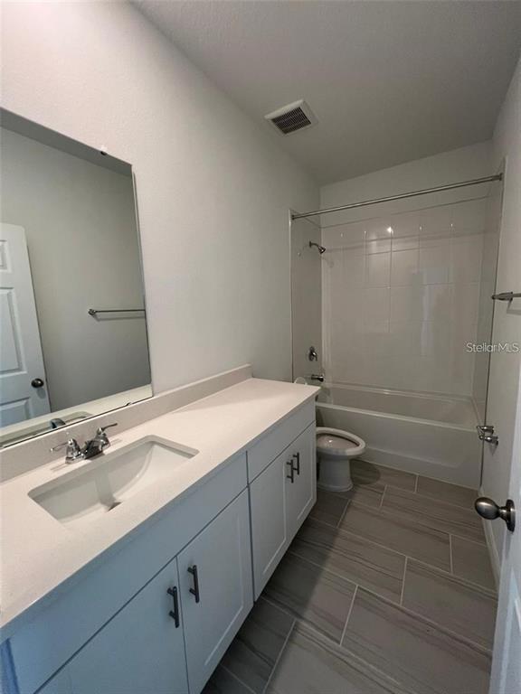 4720 Homestead Trail St. Cloud, FL 34772 - Photo 9 of 13 a bathroom with a sink a toilet and shower
