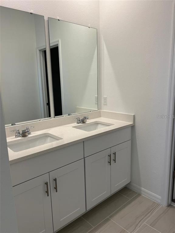 4720 Homestead Trail St. Cloud, FL 34772 - Photo 10 of 13 a bathroom with a sink and a mirror