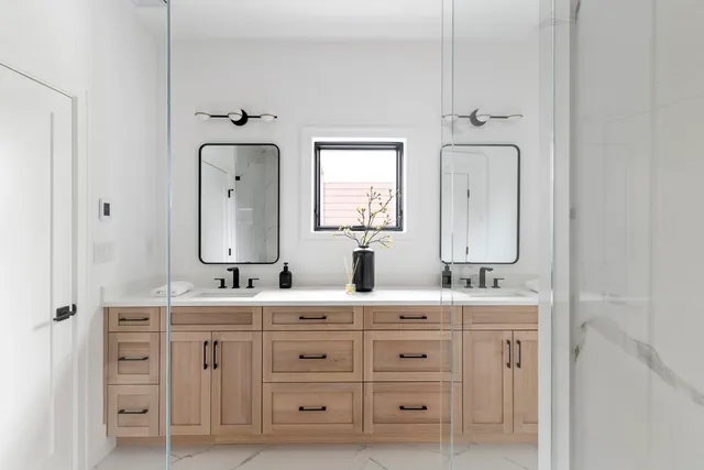 a bathroom with a double vanity sink double and mirror