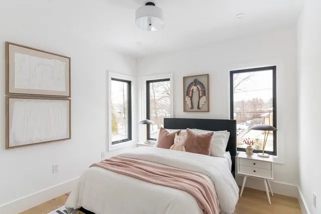 a bedroom with a large bed and a window