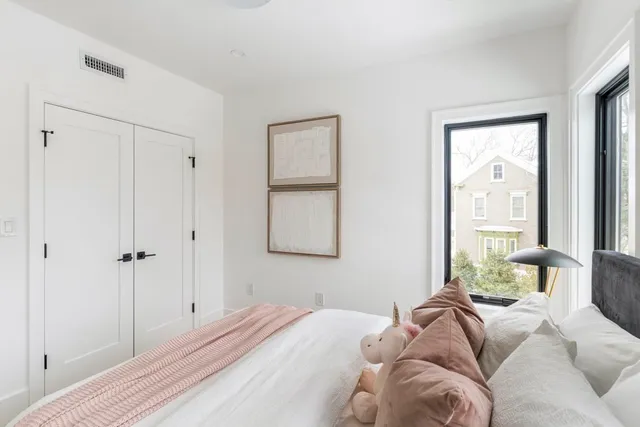 a bedroom with a bed and a window