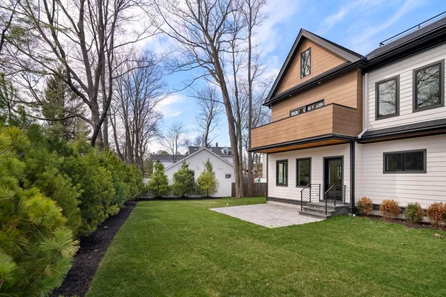 a view of a house with backyard and porch