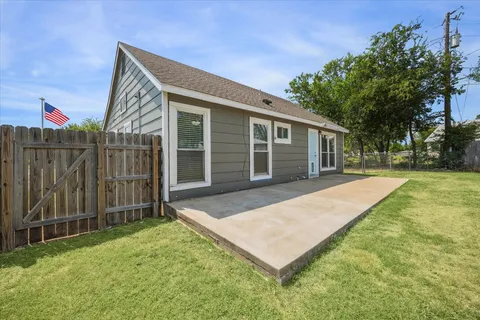 a backyard of a house with table and chairs