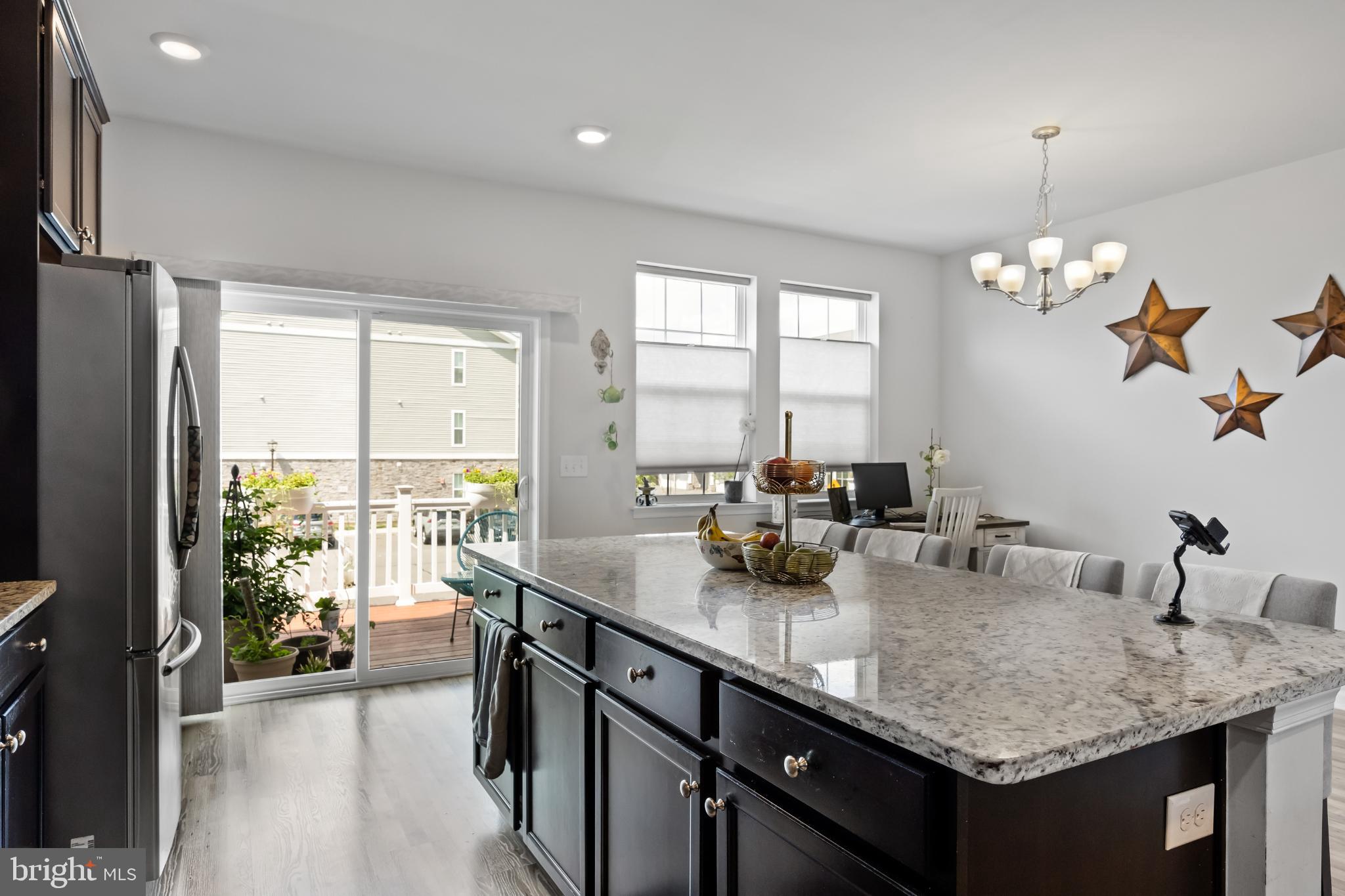 6 Rome Way Mount Laurel, NJ 08054 - Photo 15 of 28 a dining hall with stainless steel appliances granite countertop a sink dishwasher and a flat tv screen next to a large window with garden view