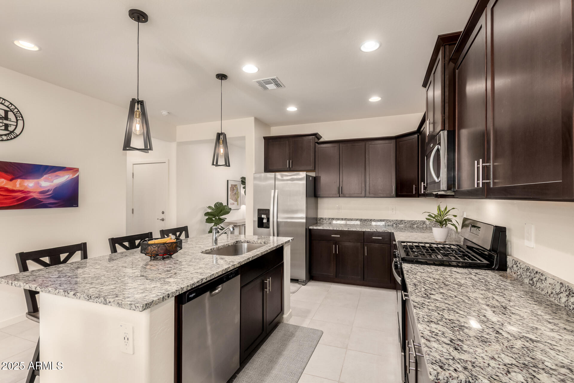 20485 North Candlelight Road Maricopa, AZ 85138 - Photo 11 of 26 a kitchen with stainless steel appliances granite countertop sink stove and refrigerator