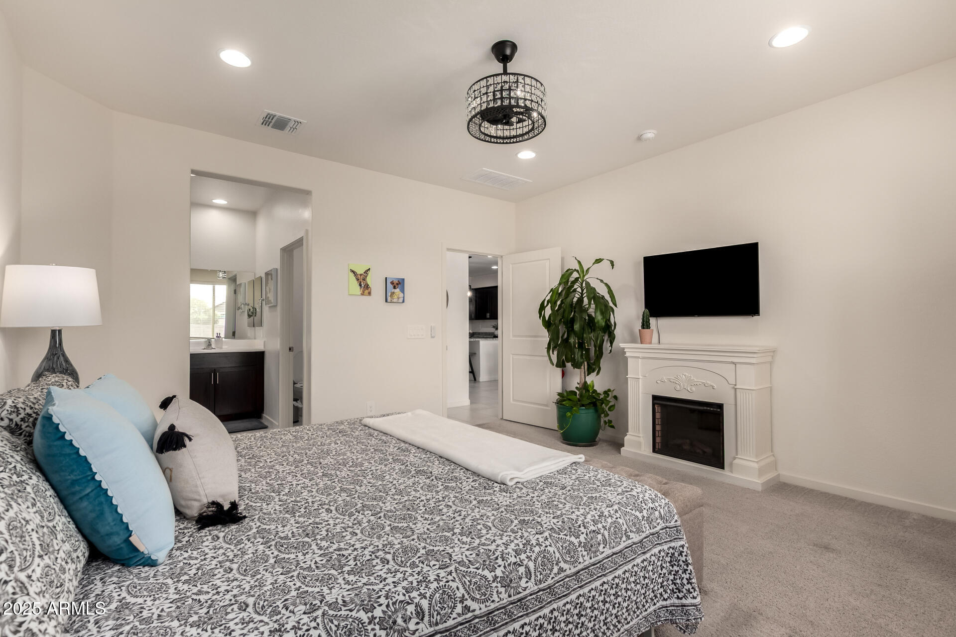 20485 North Candlelight Road Maricopa, AZ 85138 - Photo 14 of 26 a bedroom with a bed and a flat screen tv