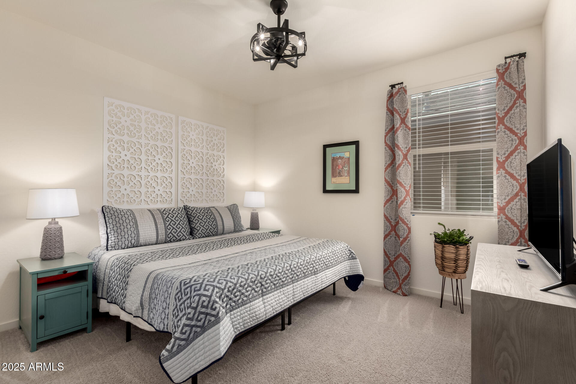 20485 North Candlelight Road Maricopa, AZ 85138 - Photo 18 of 26 a bedroom with a bed and a flat tv screen on dresser