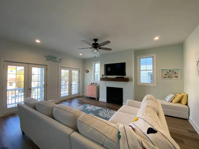a living room with furniture flat screen tv and a fireplace