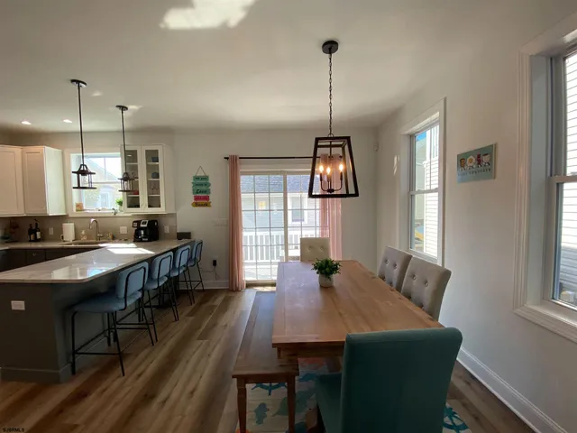 a kitchen with counter space dining table and chairs